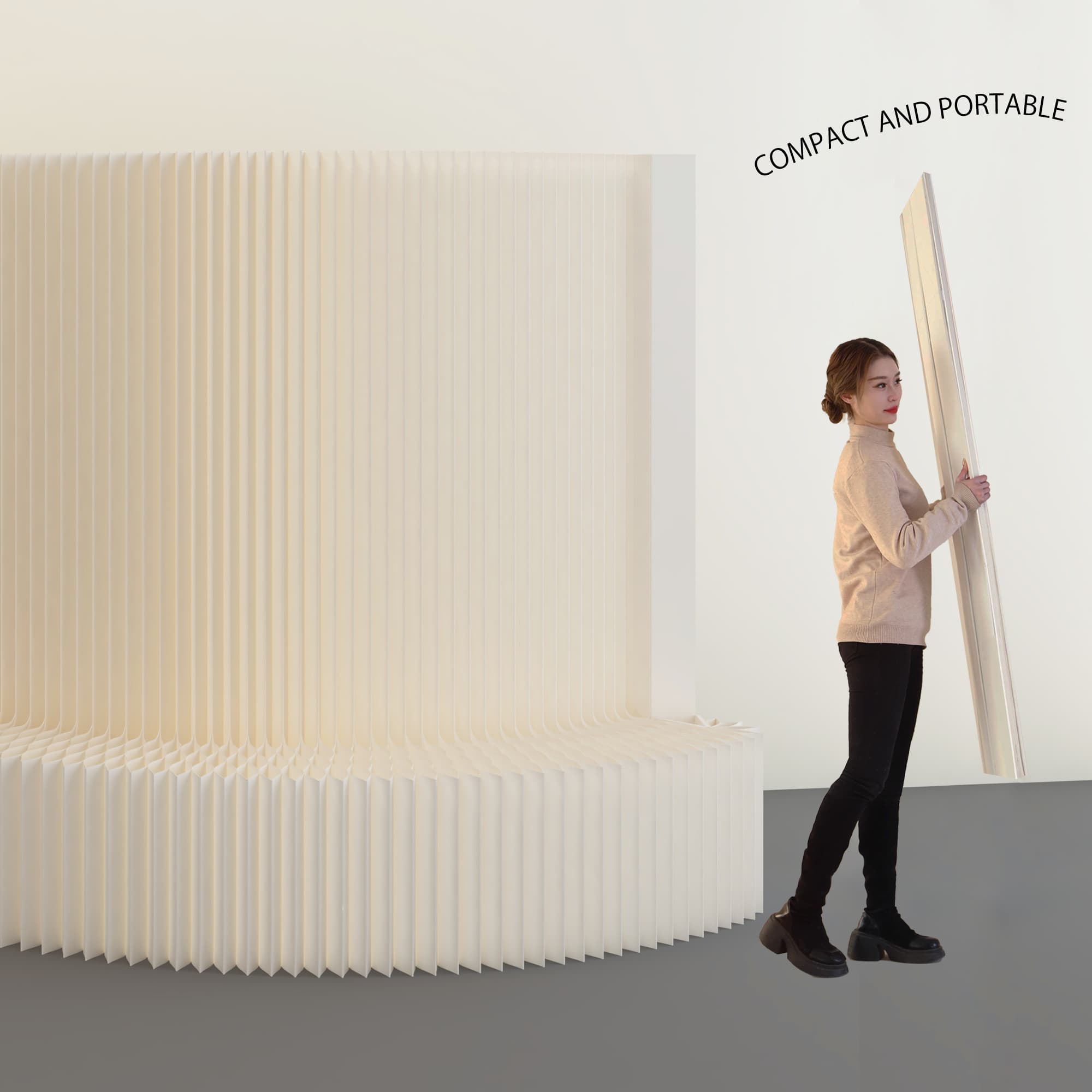 One person carrying the folded paper display wall under one arm